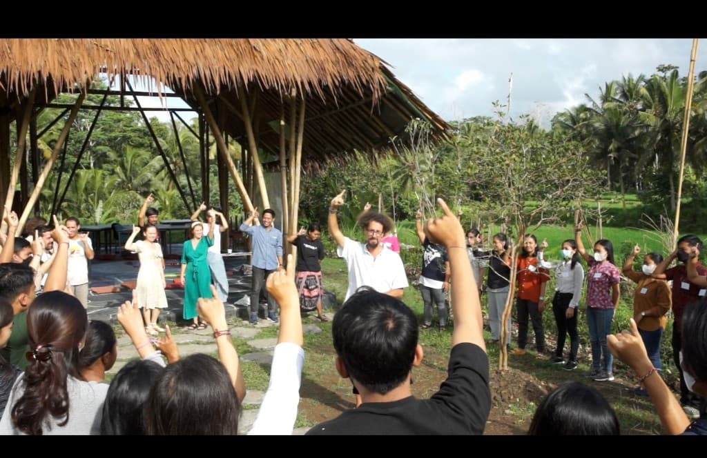 Large group workshop in outdoor bamboo pavilion